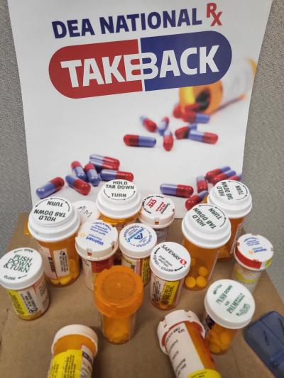 DEA National Drug Take Back sign with pill bottles